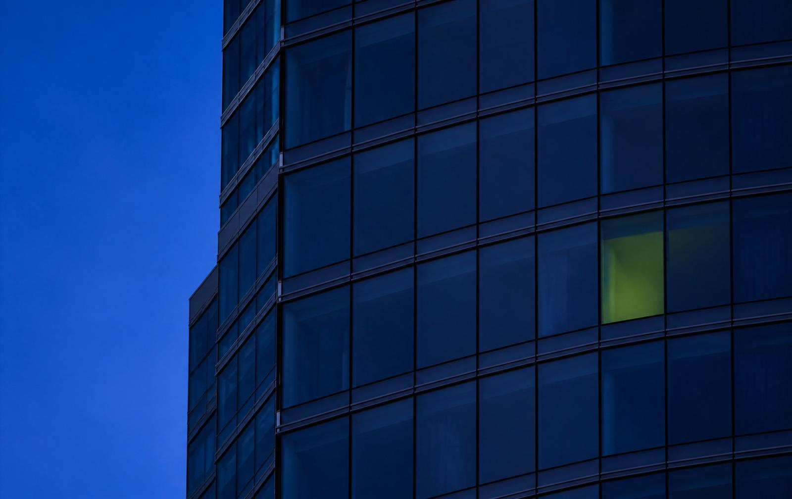 Modern glass facade of a UAE tower at blue hour